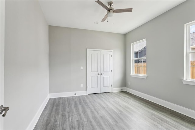 1827-29 Frenchmen St, New Orleans, LA 70116 - unfurnished bedroom featuring wood finished floors, baseboards, a closet, and a ceiling fan