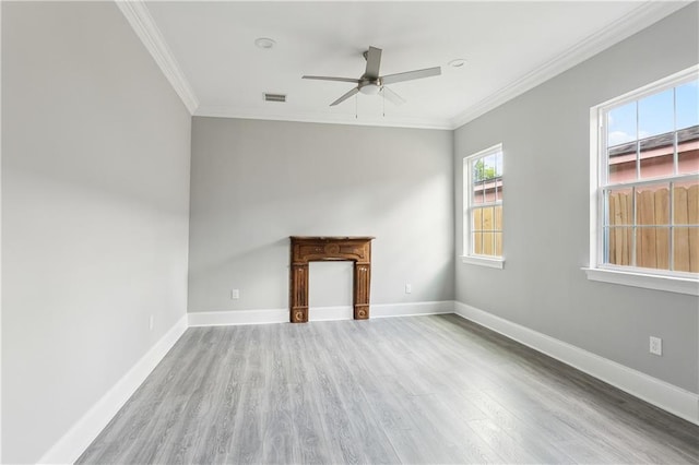 1827-29 Frenchmen St, New Orleans, LA 70116 - unfurnished living room with wood finished floors, ceiling fan, crown molding, and baseboards
