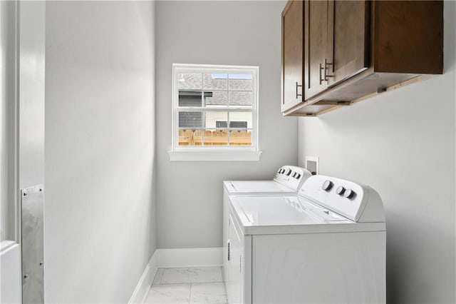 1827-29 Frenchmen St, New Orleans, LA 70116 - laundry room featuring cabinet space, separate washer and dryer, light marble finish flooring, and baseboards