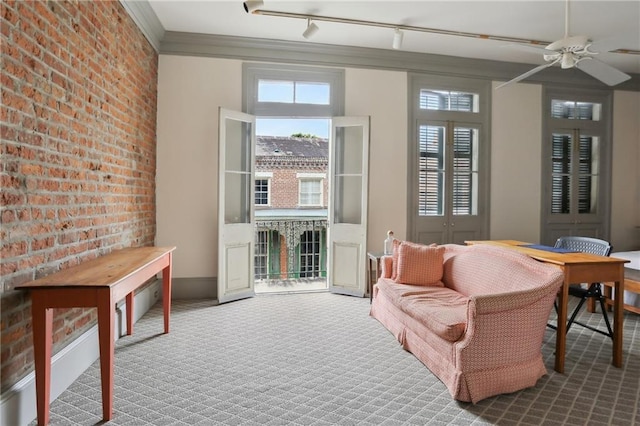 1138-1140 Chartres St, New Orleans, LA 70116 - living area with brick wall, carpet flooring, crown molding, and ceiling fan