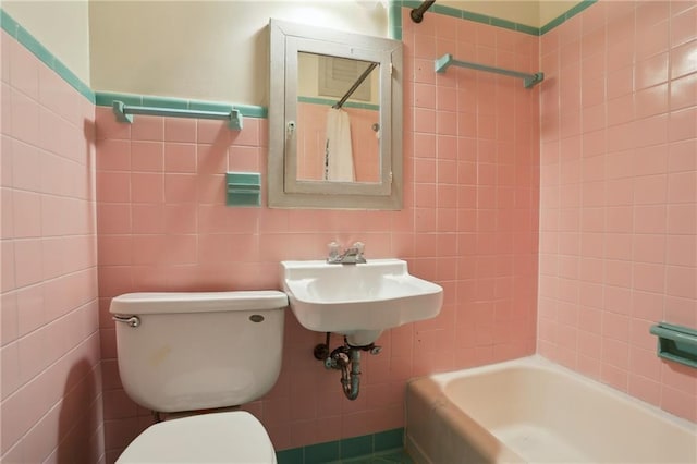 1138-1140 Chartres St, New Orleans, LA 70116 - bathroom featuring tile walls, toilet, and a sink