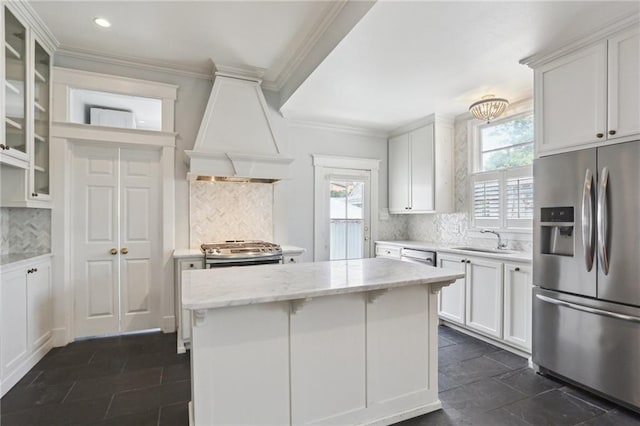 4198 Dumaine St, New Orleans, LA 70119 - kitchen featuring appliances with stainless steel finishes, premium range hood, plenty of natural light, a sink, and ornamental molding