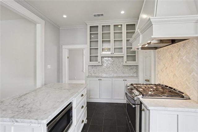 4198 Dumaine St, New Orleans, LA 70119 - kitchen with appliances with stainless steel finishes, custom range hood, decorative backsplash, glass insert cabinets, and crown molding
