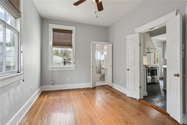 4198 Dumaine St, New Orleans, LA 70119 - unfurnished bedroom with light wood-style flooring, baseboards, and ensuite bathroom