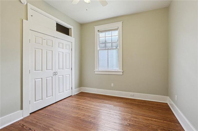 4198 Dumaine St, New Orleans, LA 70119 - unfurnished bedroom with wood finished floors, baseboards, ceiling fan, and a closet
