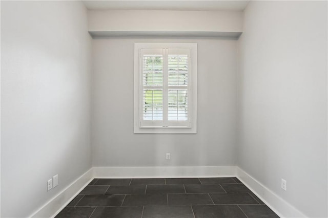4198 Dumaine St, New Orleans, LA 70119 - empty room with dark tile patterned floors and baseboards