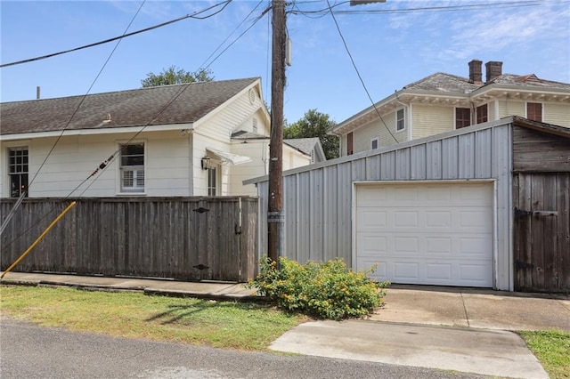 4198 Dumaine St, New Orleans, LA 70119 - view of side of property with a garage, concrete driveway, and an outdoor structure