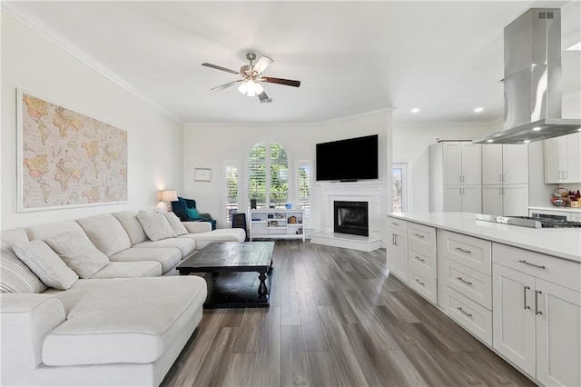 3740 Lake Lynn Dr, Gretna, LA 70056 - living area with ornamental molding, ceiling fan, dark wood finished floors, a fireplace with raised hearth, and recessed lighting