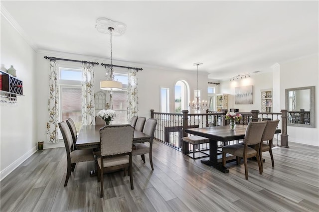 3740 Lake Lynn Dr, Gretna, LA 70056 - dining area featuring a chandelier, wood finished floors, baseboards, and ornamental molding