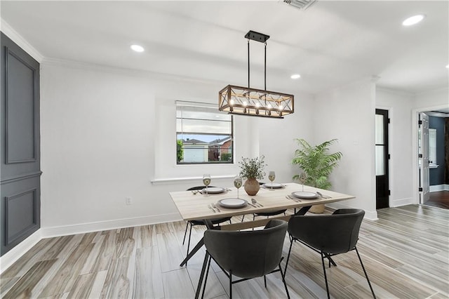 2024 Manson Ave, Metairie, LA 70001 - dining space with baseboards, crown molding, light wood finished floors, recessed lighting, and a chandelier