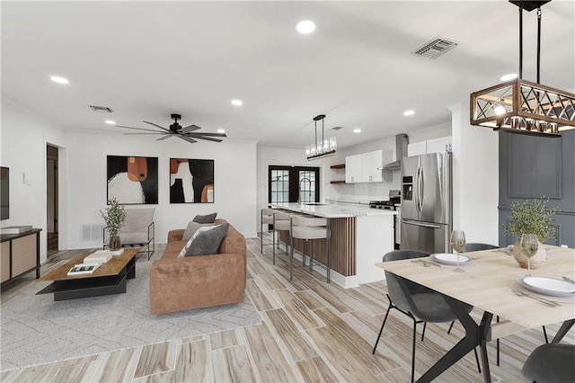 2024 Manson Ave, Metairie, LA 70001 - living room featuring recessed lighting, a ceiling fan, light wood-style floors, and a chandelier