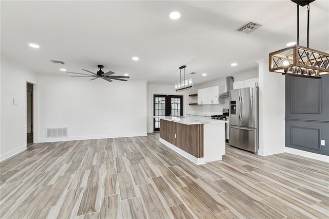 2024 Manson Ave, Metairie, LA 70001 - kitchen featuring stainless steel fridge with ice dispenser, light countertops, recessed lighting, wall chimney range hood, and ceiling fan
