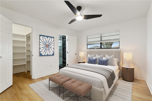 2024 Manson Ave, Metairie, LA 70001 - bedroom with a walk in closet, baseboards, light wood-style floors, a ceiling fan, and a closet