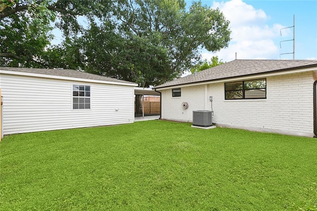 2024 Manson Ave, Metairie, LA 70001 - rear view of property featuring a lawn, brick siding, cooling unit, and roof with shingles