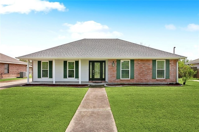 255 Wilson Ln, Belle Chasse, LA 70037 - ranch-style house featuring cooling unit, covered porch, a front yard, and roof with shingles