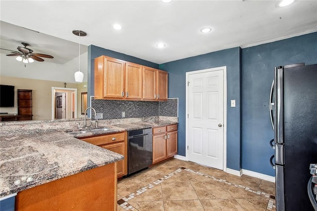 255 Wilson Ln, Belle Chasse, LA 70037 - kitchen featuring black dishwasher, freestanding refrigerator, a sink, baseboards, and light stone counters