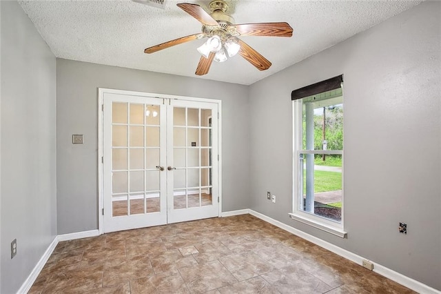 255 Wilson Ln, Belle Chasse, LA 70037 - spare room with french doors, a textured ceiling, a ceiling fan, and baseboards