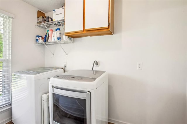 255 Wilson Ln, Belle Chasse, LA 70037 - laundry room featuring cabinet space and washing machine and dryer