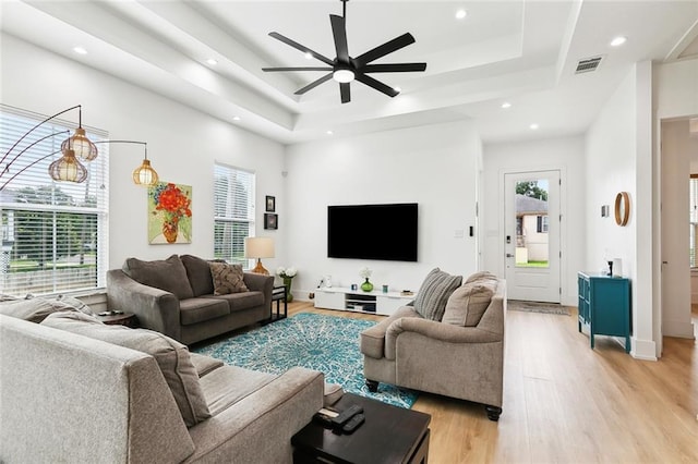 2535 Athis St, New Orleans, LA 70122 - living area featuring a raised ceiling, a ceiling fan, light wood-style floors, and recessed lighting
