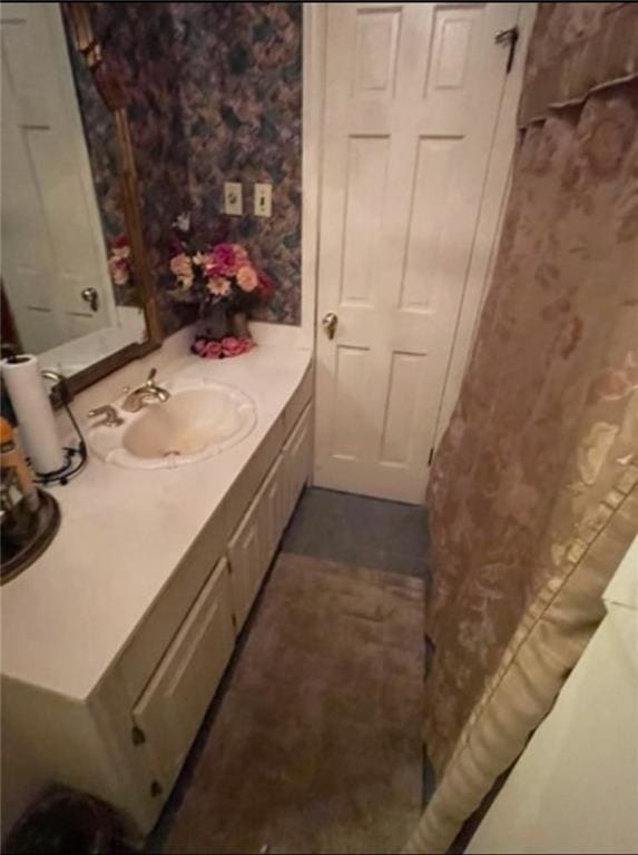 3867 N Teak Ave, New Orleans, LA 70131 - bathroom with wallpapered walls and vanity