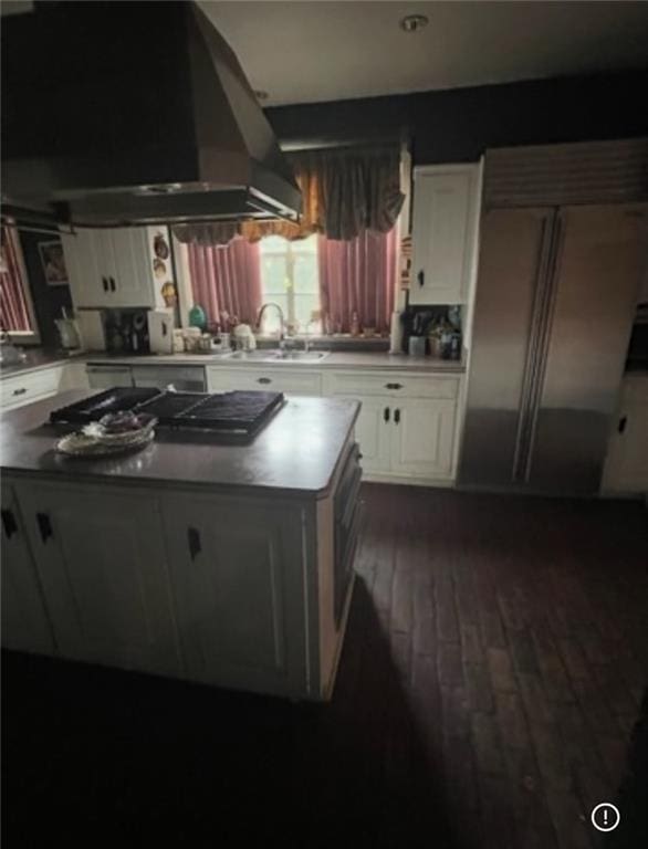 3867 N Teak Ave, New Orleans, LA 70131 - kitchen featuring wall chimney exhaust hood, a center island, a sink, white cabinets, and stainless steel built in refrigerator