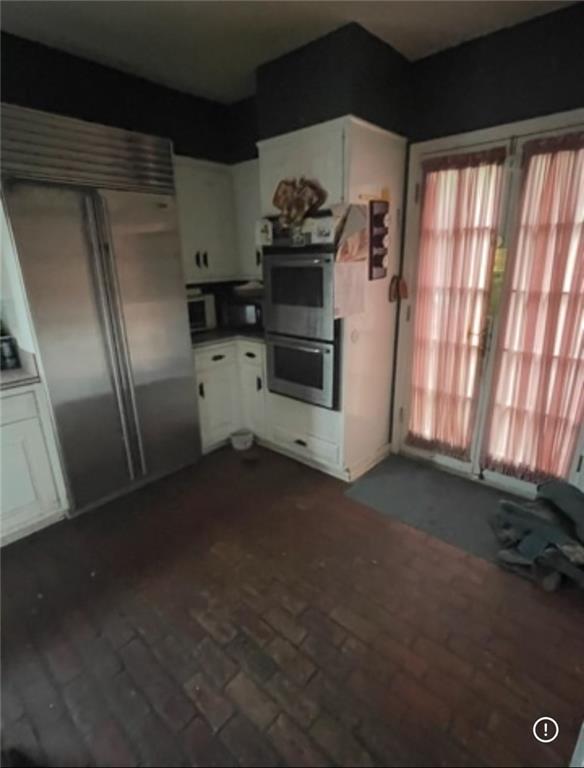3867 N Teak Ave, New Orleans, LA 70131 - kitchen with stainless steel appliances, healthy amount of natural light, and white cabinetry
