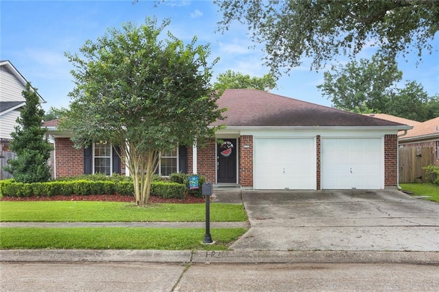 1113 Linwood Ave, Metairie, LA 70003 - view of front facade featuring brick siding, an attached garage, a front yard, and driveway