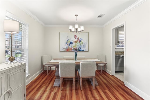 1113 Linwood Ave, Metairie, LA 70003 - dining space featuring a chandelier, light wood finished floors, baseboards, and crown molding