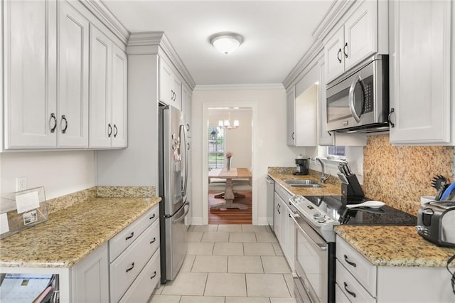 1113 Linwood Ave, Metairie, LA 70003 - kitchen with appliances with stainless steel finishes, a sink, backsplash, a chandelier, and white cabinetry