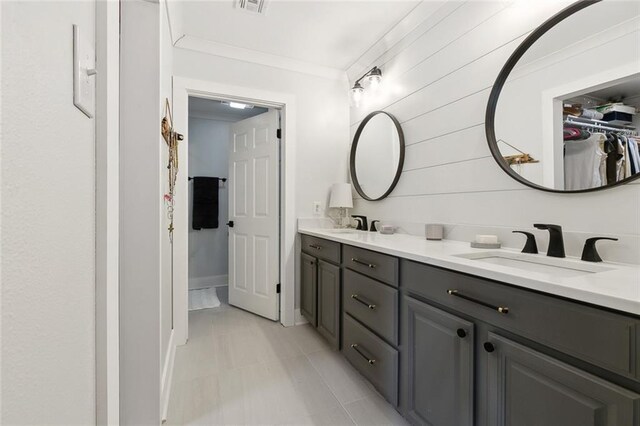 502 Audubon Trce Unit 502, Jefferson, LA 70121 - bathroom featuring double vanity, a spacious closet, and crown molding