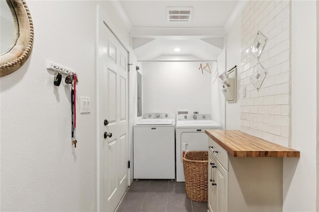 502 Audubon Trce Unit 502, Jefferson, LA 70121 - laundry room with washing machine and clothes dryer, dark tile patterned flooring, cabinet space, ornamental molding, and recessed lighting