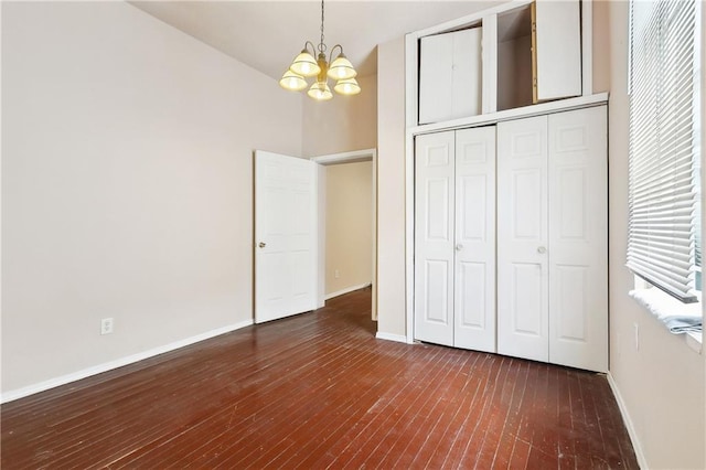 3114 Audubon St, New Orleans, LA 70125 - unfurnished bedroom featuring a chandelier, baseboards, wood finished floors, and a closet