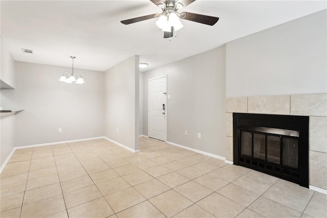 303 Parkview Blvd Unit 303, Mandeville, LA 70471 - unfurnished living room featuring a chandelier, ceiling fan, a fireplace, and light tile patterned floors