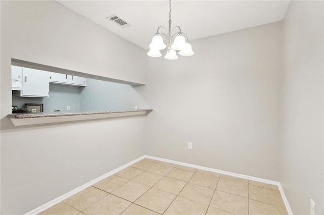 303 Parkview Blvd Unit 303, Mandeville, LA 70471 - unfurnished dining area with a chandelier, baseboards, and light tile patterned floors