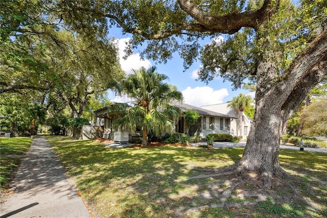 1141 Allen Toussaint Blvd, New Orleans, LA 70124 - obstructed view of property featuring a front lawn