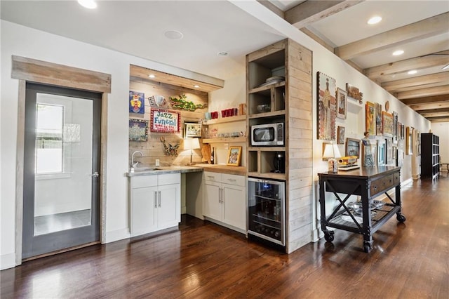 1141 Allen Toussaint Blvd, New Orleans, LA 70124 - indoor wet bar with beverage cooler, stainless steel microwave, dark wood finished floors, beam ceiling, and recessed lighting