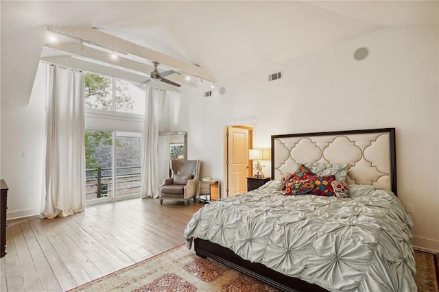 1141 Allen Toussaint Blvd, New Orleans, LA 70124 - bedroom with rail lighting, access to exterior, high vaulted ceiling, wood-type flooring, and baseboards