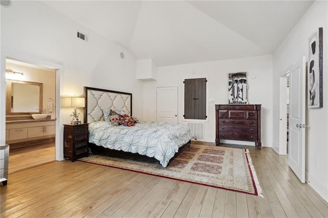 1141 Allen Toussaint Blvd, New Orleans, LA 70124 - bedroom with hardwood / wood-style floors, high vaulted ceiling, and ensuite bath