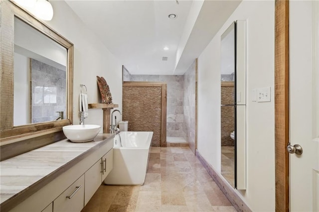 1141 Allen Toussaint Blvd, New Orleans, LA 70124 - bathroom featuring vanity, a freestanding tub, walk in shower, recessed lighting, and toilet