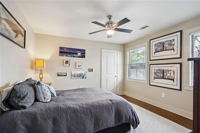 1141 Allen Toussaint Blvd, New Orleans, LA 70124 - bedroom with baseboards, dark wood finished floors, and a ceiling fan