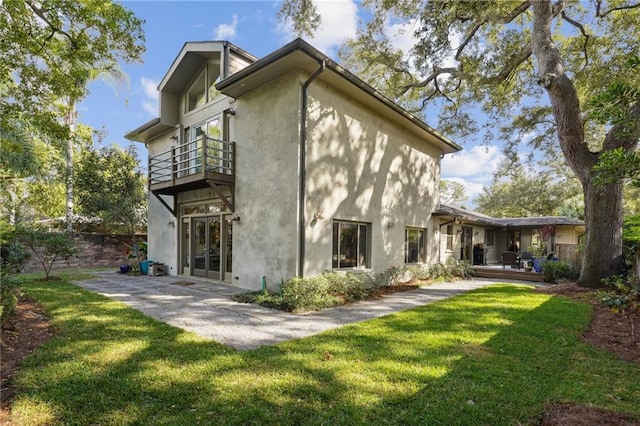 1141 Allen Toussaint Blvd, New Orleans, LA 70124 - back of house with a balcony, stucco siding, and french doors