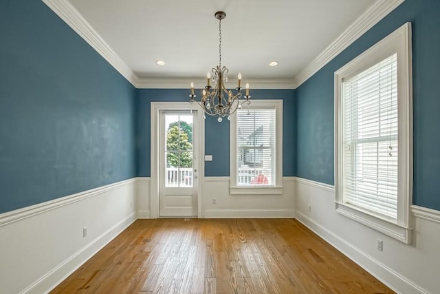 433 S Cortez St, New Orleans, LA 70119 - unfurnished dining area with a chandelier, hardwood / wood-style flooring, crown molding, and baseboards