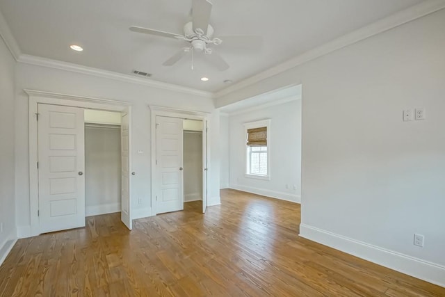433 S Cortez St, New Orleans, LA 70119 - unfurnished bedroom with ornamental molding, multiple closets, baseboards, wood finished floors, and recessed lighting