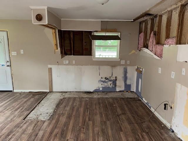 10836 Big Sur Dr, Baton Rouge, LA 70818 - kitchen with wood finished floors, dark brown cabinetry, and crown molding