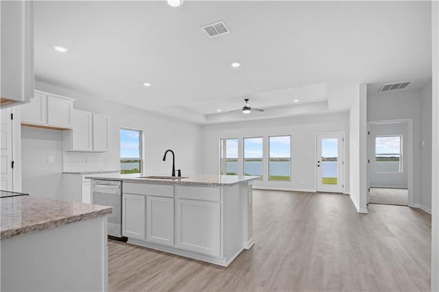 5357 Bypass Breeze Ave, Slidell, LA 70461 - kitchen with dishwasher, a raised ceiling, a sink, light wood finished floors, and recessed lighting