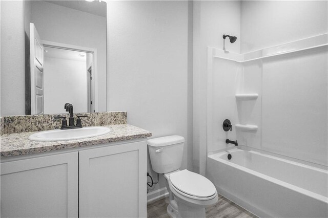 5357 Bypass Breeze Ave, Slidell, LA 70461 - bathroom featuring toilet, vanity, wood finished floors, and shower / washtub combination