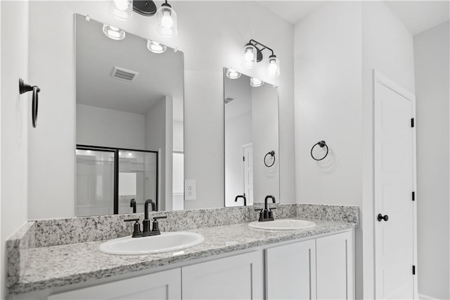 5357 Bypass Breeze Ave, Slidell, LA 70461 - bathroom with double vanity, an enclosed shower, and a closet