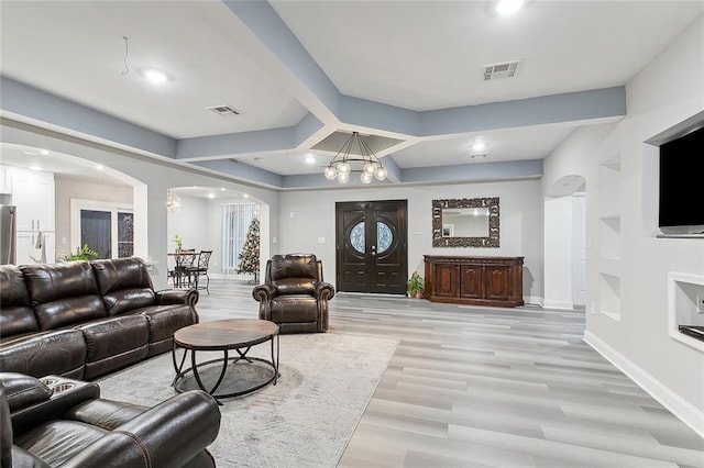 1713 Thomas St, Gretna, LA 70053 - living room featuring arched walkways, a chandelier, light wood finished floors, and recessed lighting