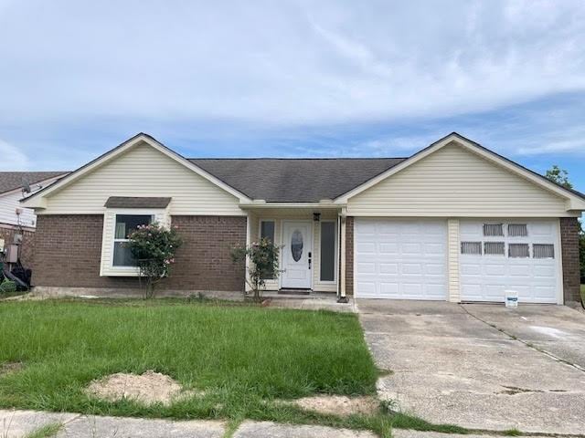 2120 Killington Dr, Harvey, LA 70058 - ranch-style house featuring a garage, brick siding, concrete driveway, and a front yard