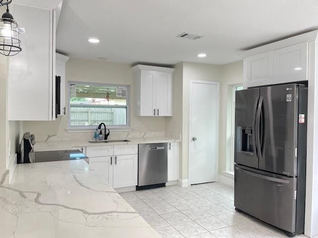 2120 Killington Dr, Harvey, LA 70058 - kitchen with appliances with stainless steel finishes, a sink, white cabinetry, light stone counters, and recessed lighting